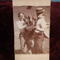 Lot 136 - Trimmed Small Boarded Photo - The A.K.K. Goat Owned By Dr. T.A. Bakemen, Two Men Holding Goat, Comical Photo