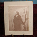 Lot 138 - Small Boarded Photo - Young Man In Costume With Fake Mustache Smoking Cigarette, Against White Sheet, Tree Branch