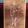 Lot 147 - Cabinet Card - Solder Standing With Hand Resting On Sword Hilt, Cap, Stripe Down Pants, Outdoor Photo, Wearing Medal