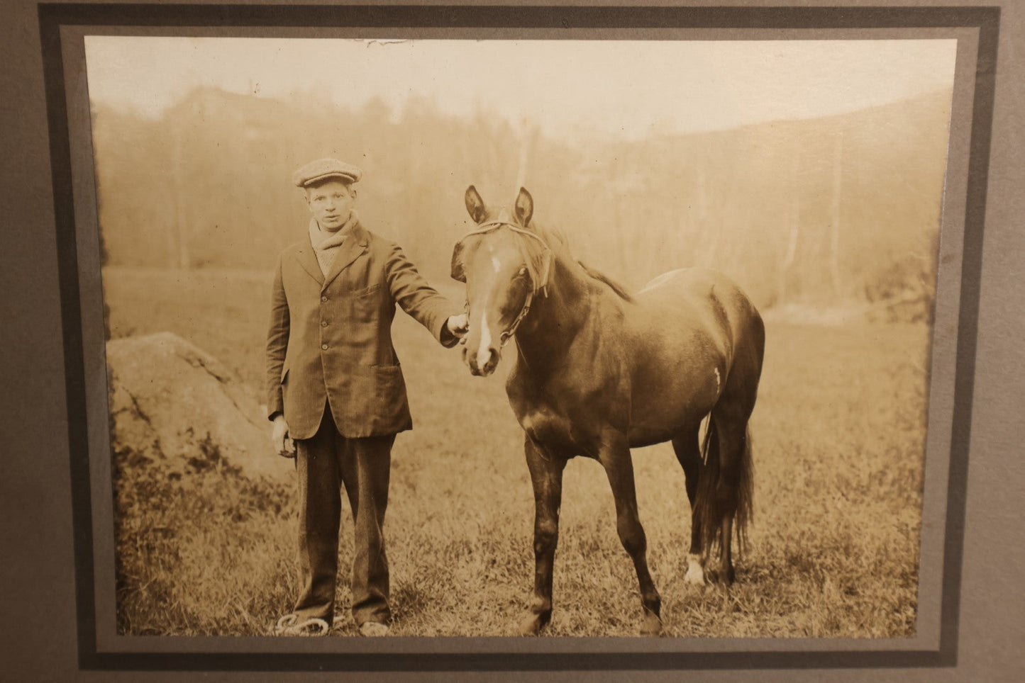 Lot 154 - Boarded Photo - Young Man In Scally Cap Holding Small Horse, Outdoor Photo