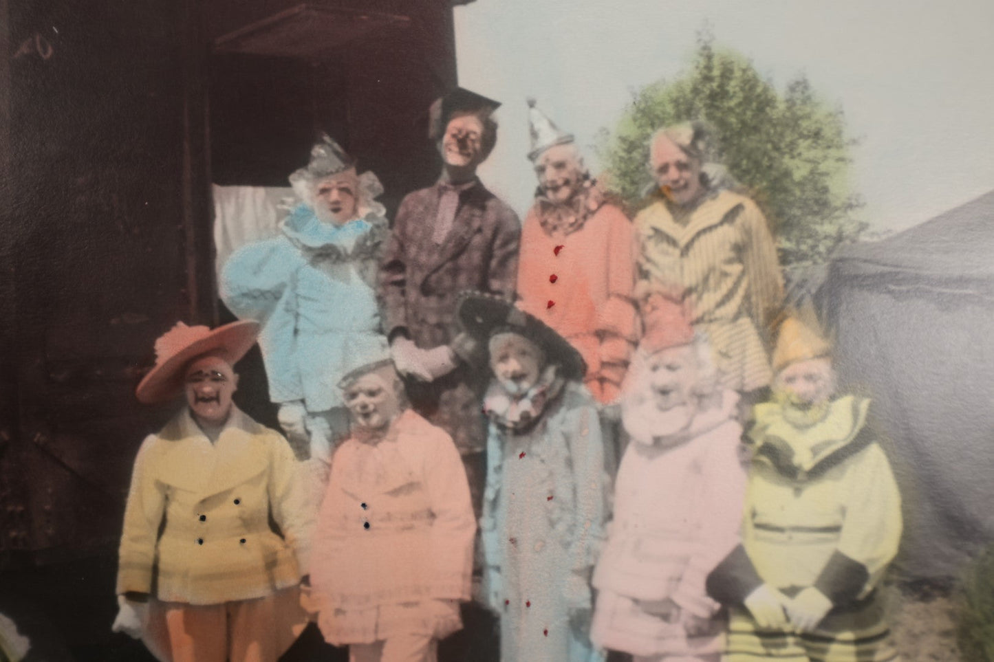 Lot 021 - Antique Colored Photograph of Nine Clowns In Costume By Circu Train, Tent, Early Sideshow Behind The Scenes Photo