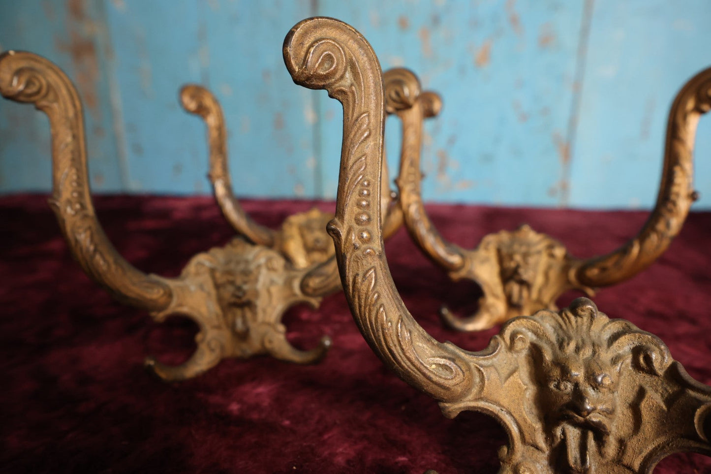 Lot 024 - Grouping of Four Antique Neoclassical Ornate Gold Painted Cast Iron Hardware Coat Hangers With Figural Lion Face With Flanges, Screws, Nuts