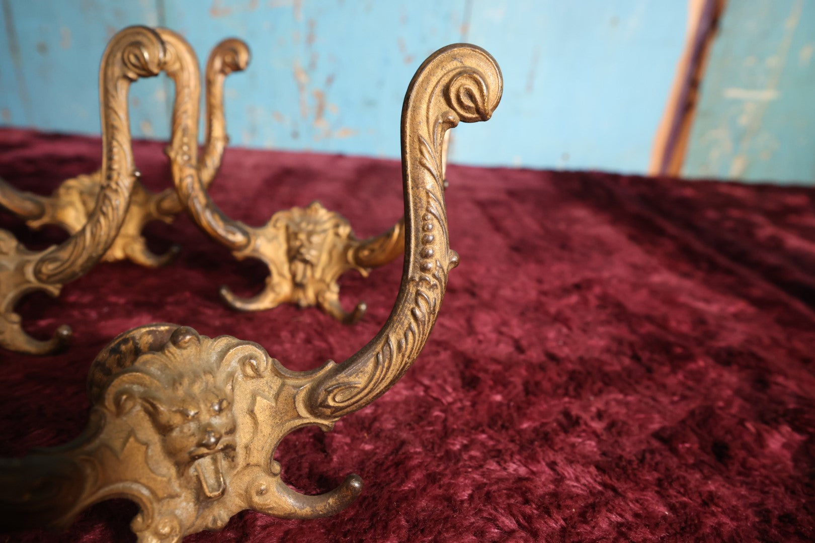 Lot 024 - Grouping of Four Antique Neoclassical Ornate Gold Painted Cast Iron Hardware Coat Hangers With Figural Lion Face With Flanges, Screws, Nuts