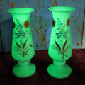 Lot 029 - Pair of Vintage Uranium Glass Vases, Opaque Glass With Hand Painted Floral Details, Strong Glow Under U.V., Note Each Has Chip On Rim