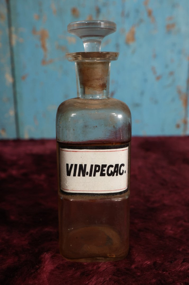 Lot 035 - Antique Vinum Ipecacuanhae / Ipecac Wine Apothecary Bottle With Glass Label, Stopper, Approximately 6.75", Emetic Used To Induce Vomiting