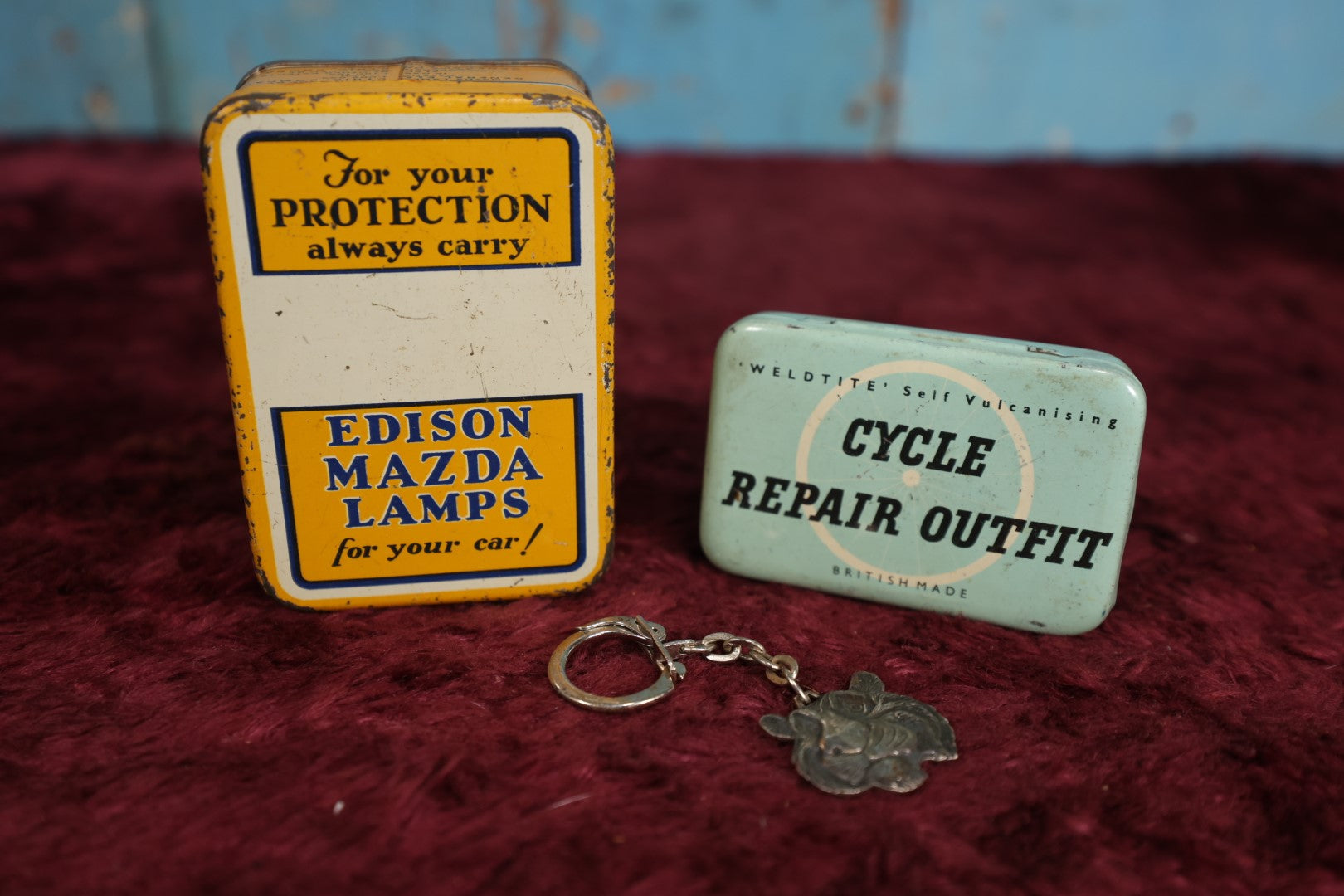 Lot 100 - Three Piece Automotive Transportation Lot - Mazda Lamps Tin, Cycle Repair Outfit Tin With Contents, And Esso Tiger Keychain