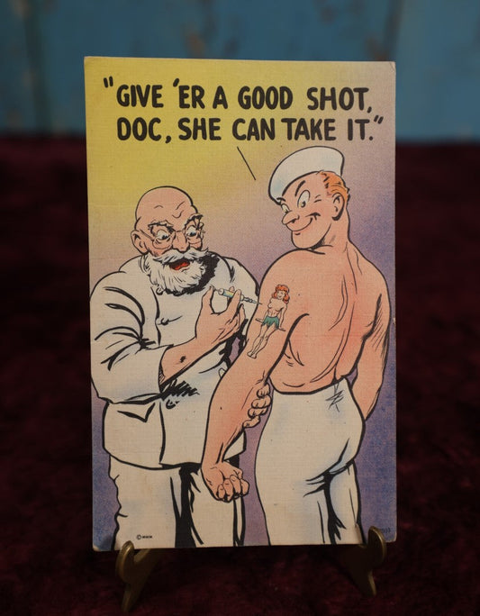 Lot 105 - Vintage Navy Tattoo Novelty Postcard, "Give 'Er A Shot, Doc," M.W.M. Color-Litho Postcard, Aurora, Missouri