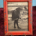 Lot 107 - Antique Framed Clipping Image Photo of Young Woman At Beach Ringing Out Her Dress, Red Painted Frame With Paint Splatter, Wood Back