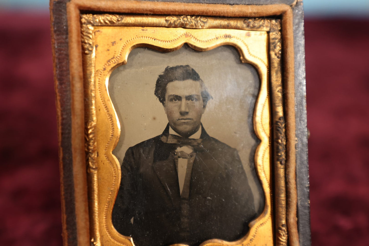 Lot 110 - Antique Ambrotype Photograph of Young Man In Bowtie, Swoopy Hair, In Half Leatherette Union Case, 1/9th Plate