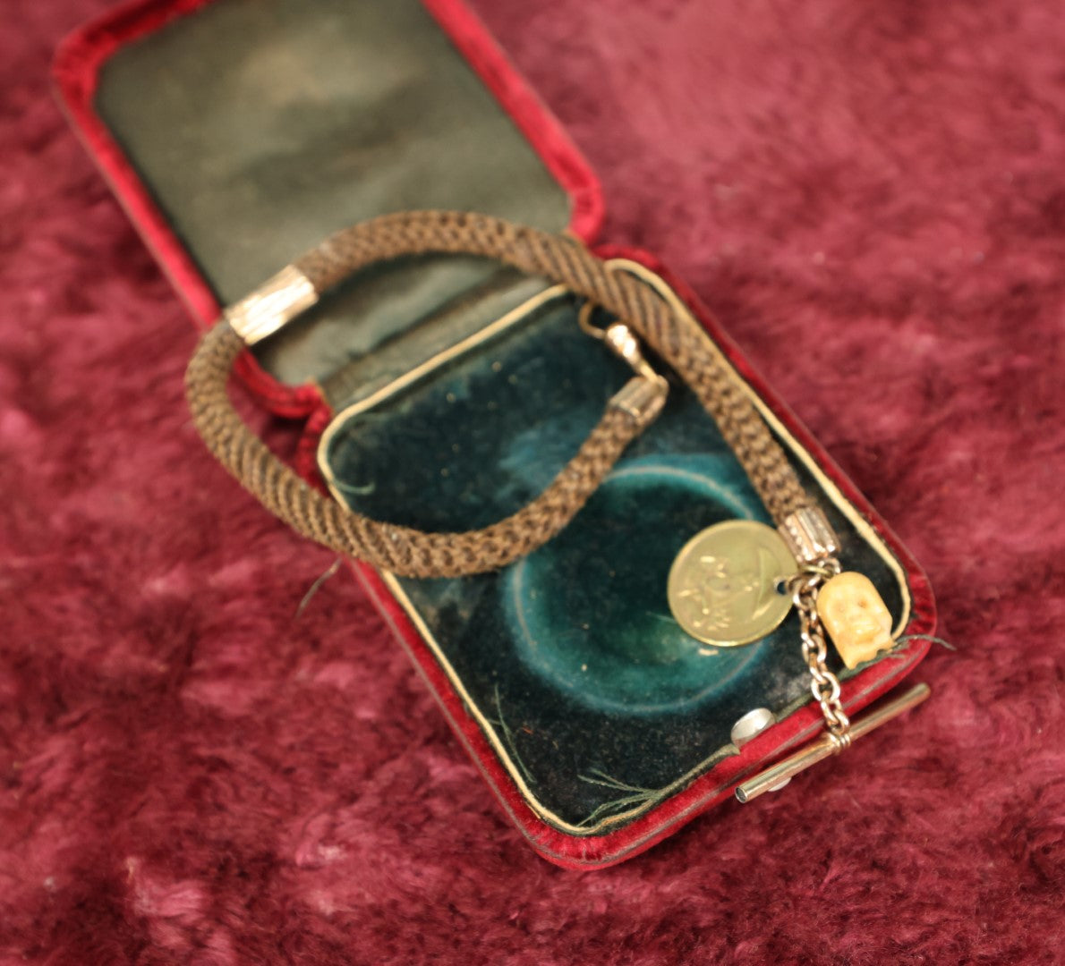 Lot 003 - Antique Victorian Human Hair Watch Chain With Carved Skull Charm And Brass Smoking Frog Coin, In Jewelry Case