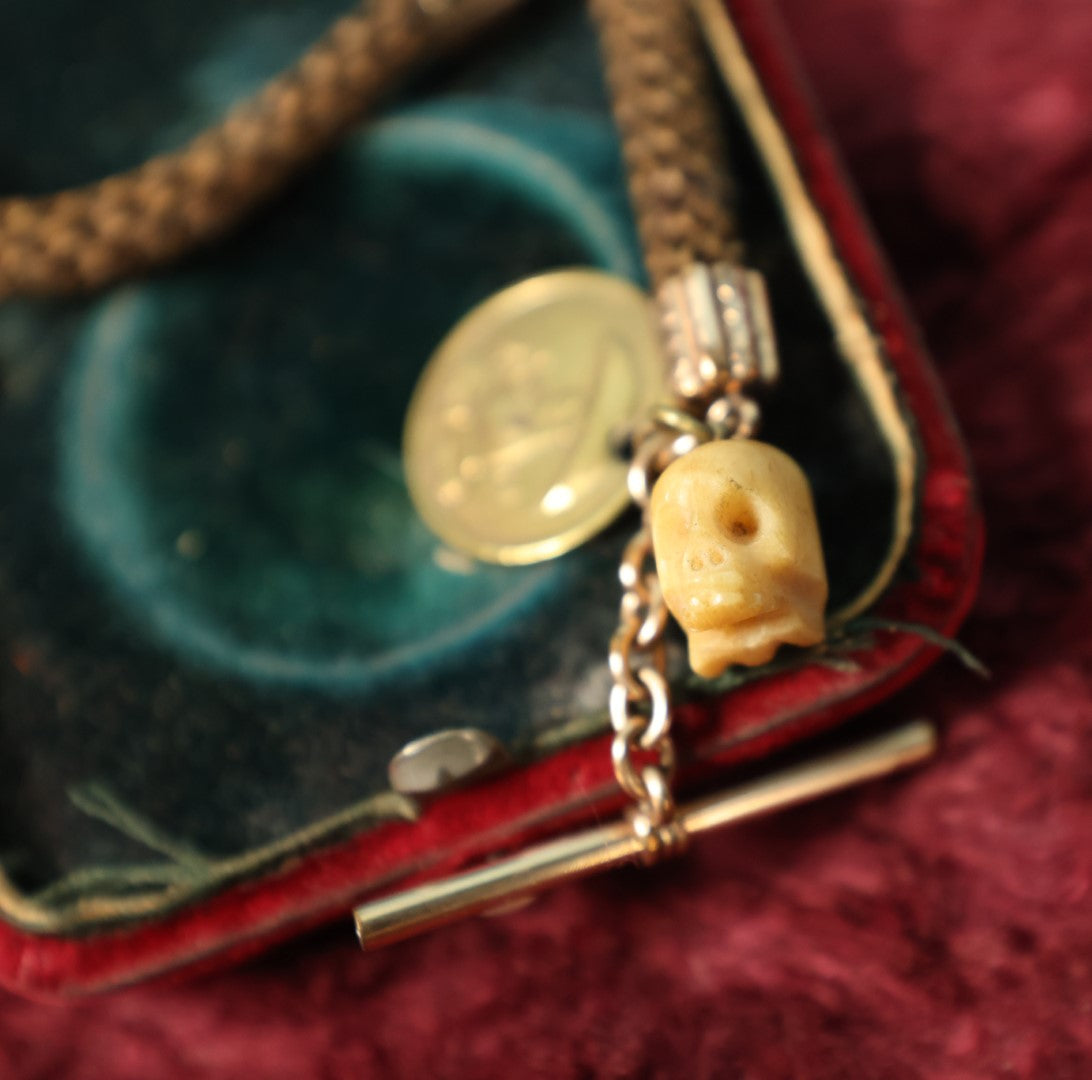 Lot 003 - Antique Victorian Human Hair Watch Chain With Carved Skull Charm And Brass Smoking Frog Coin, In Jewelry Case