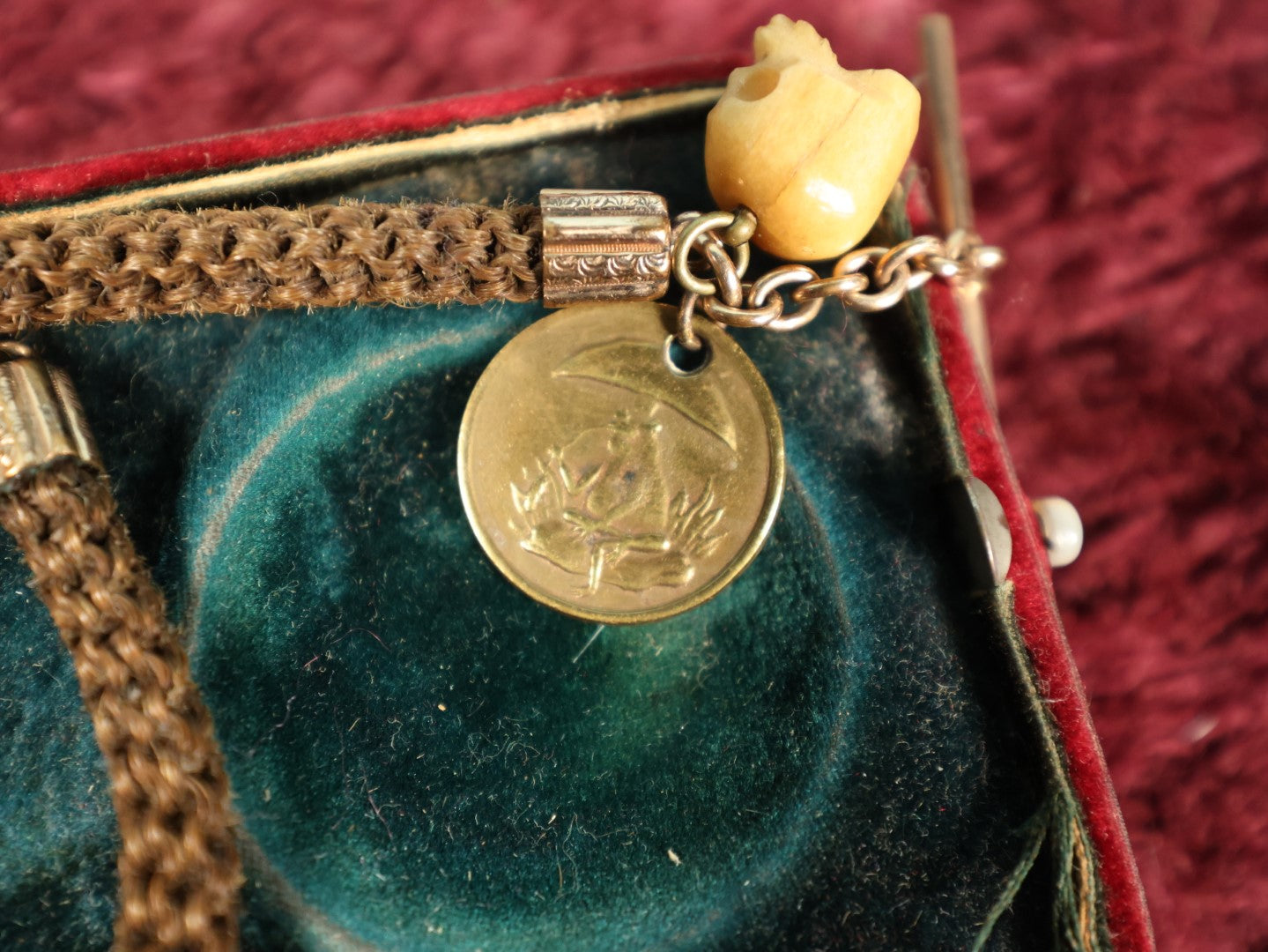 Lot 003 - Antique Victorian Human Hair Watch Chain With Carved Skull Charm And Brass Smoking Frog Coin, In Jewelry Case