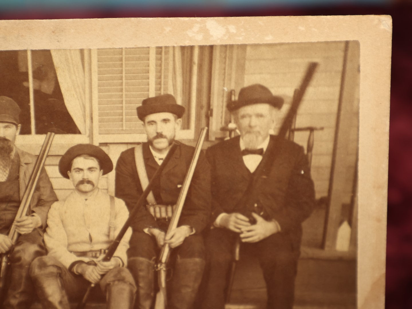 Lot 015 - Antique Boarded Photo Of Seven Men Hunters With Shotguns And Dead Bear Cub, Hunting Interest, Note Man In Window, Back Marked Ella E. Plummer