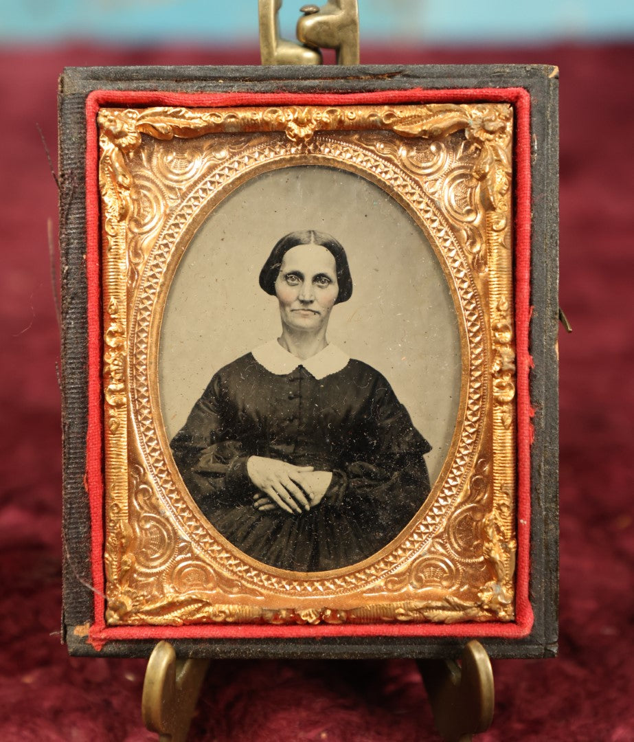 Lot 018 - Antique 1/9th Plate Ambrotype In Half Case Of Pretty Woman With Short Hair, High Cheekbones, Tinted Rosy Cheeks, Hands Crossed On Stomach