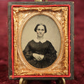 Lot 018 - Antique 1/9th Plate Ambrotype In Half Case Of Pretty Woman With Short Hair, High Cheekbones, Tinted Rosy Cheeks, Hands Crossed On Stomach