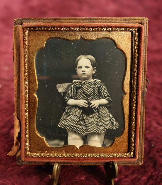 Lot 021 - Antique 1/6th Plate Daguerreotype Of Young Toddler Sitting, Looking Unsure Of Camera, Holding Something In Her Lap, In Half Case