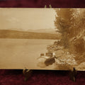 Lot 150 - Single Postcard - RPPC Real Photo Postcard Of Grand Lake Colorado, Rabbit Ears Mountains, Note Suitcase Of Photographer Visible In Boat In Photo, "Out West Photo Studio, Denver," Dated 1913