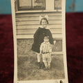 Lot 169 - Single Snapshot Photo - Young Girl With Creepy, Tall Doll