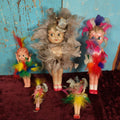 Lot 023 - Grouping Of Five Vintage Celluloid Kewpie-Like Dolls With Elaborate Feathers, Varying Damage, One Lot One Money, Made In Japan, Occupied Japan