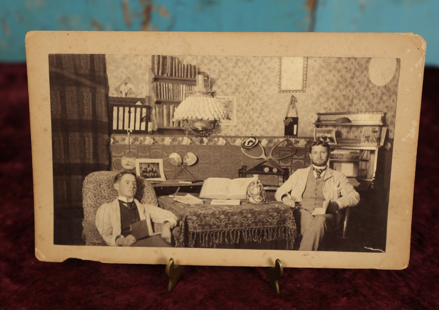 Lot 067 - Antique Interior Boarded Photo, Likely From A College Campus, Of Two Men With Tennis Rackets, Early Light Fixtures, Furniture, Back Marked Professor N.J. Merrill, 1889