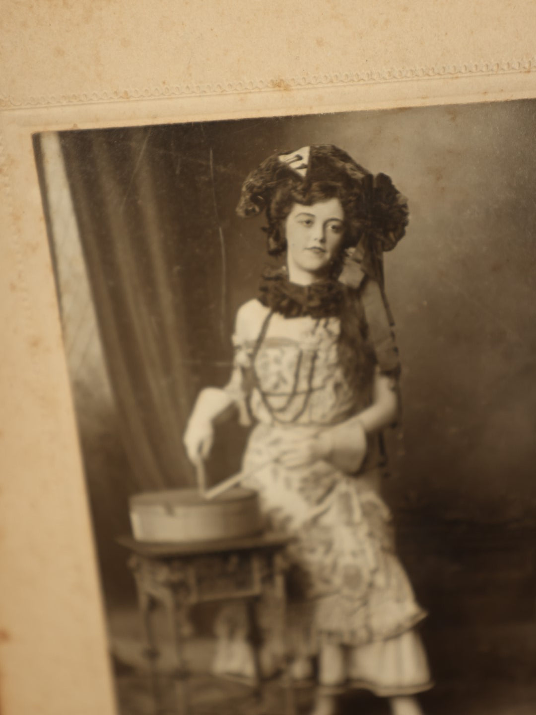 Lot 068 - Antique Boarded Photo Of Pretty Woman With Elaborate Costume, Drumming, Photographed By Charles "Chas" Betz Of Louisville, Kentucky, "Love To Mama And Papa From Florence," Writing On Back