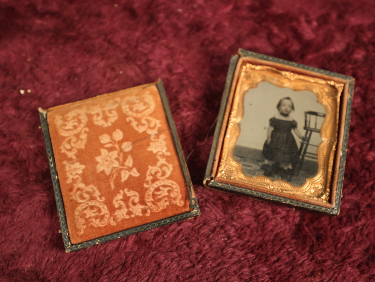 Lot 073 - Antique 1/6th Plate Ruby Ambrotype Of Young Girl Toddler Holding High Chair, Dark Off The Shoulders Dress, Heavy Wear To Case