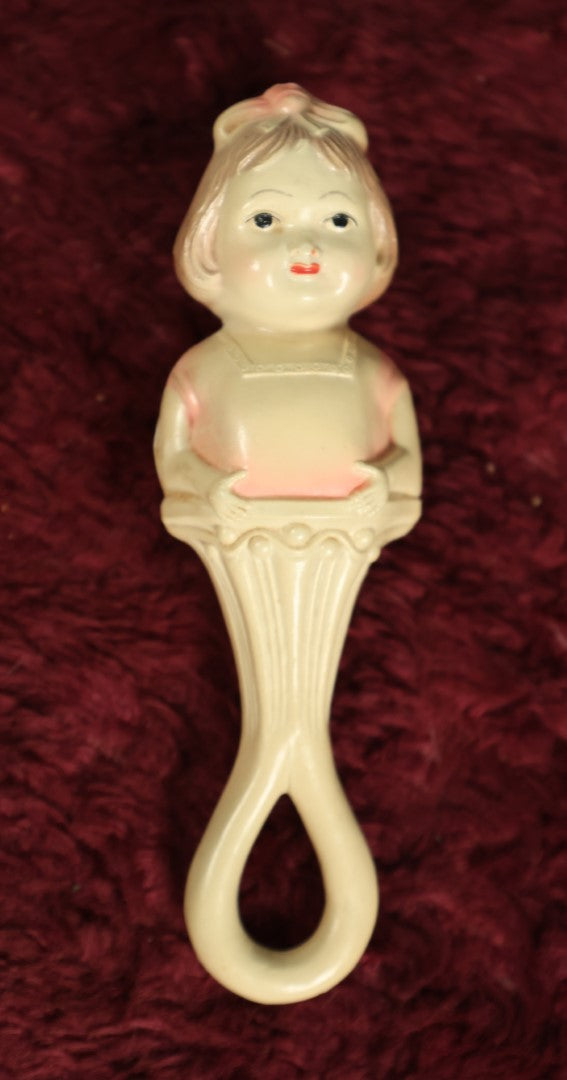 Lot 082 - Vintage Celluloid Baby Toy Figural Rattle With Little Girl, Pink Shirt, Note Split On Back, Contents Lost, Maker's Mark