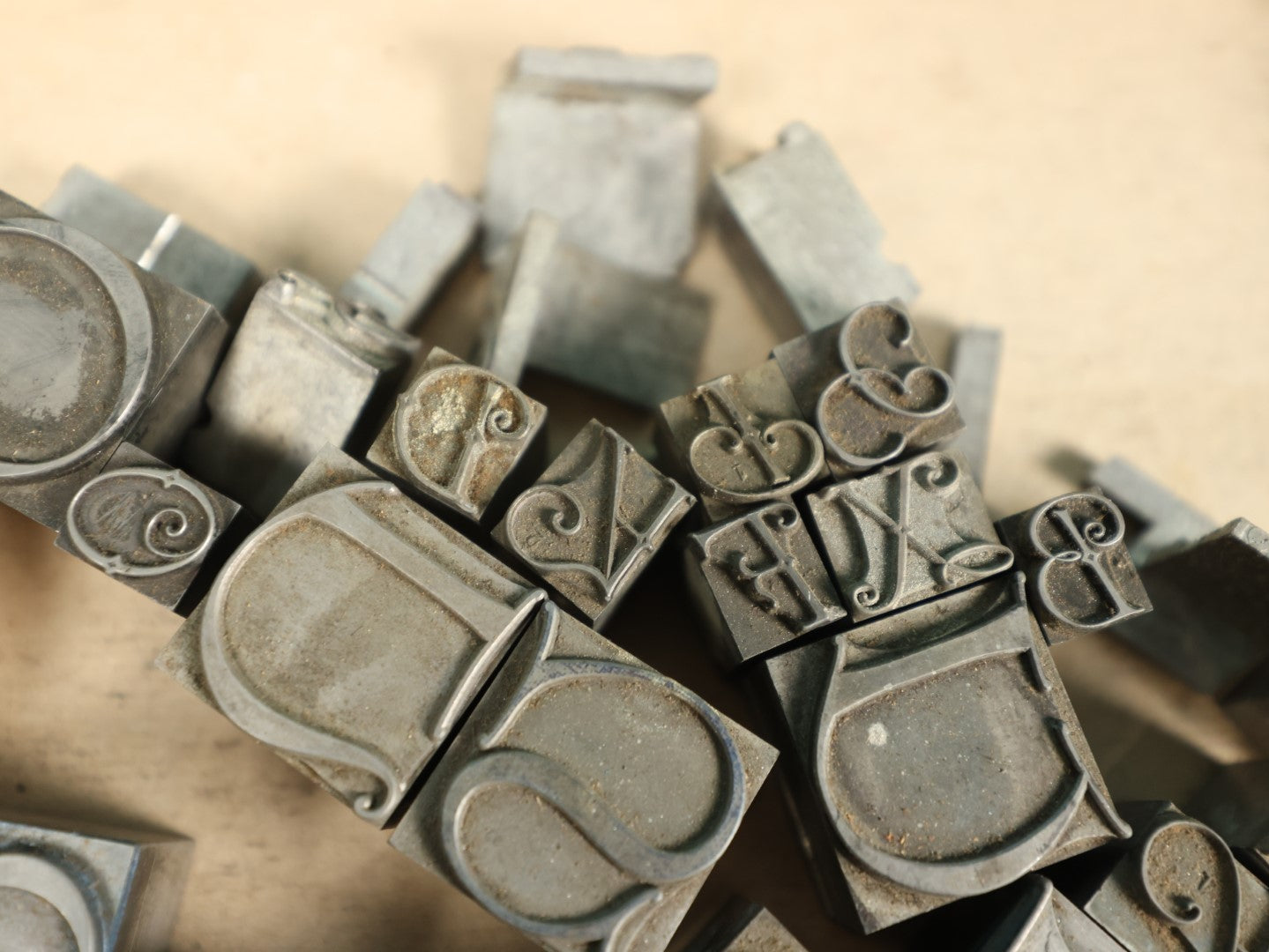 Lot 092 - Grouping Of Antique Solid Metal Letter Press Printing Block Stamps, Curvy Letters And More, 50+, Drop Caps, And Others