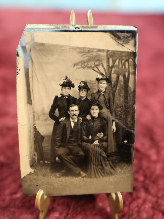 Lot 123 - Single Tintype Photo, Group Of Four Women And A Man, Painted Backdrop With Edges Of Backdrop Visible