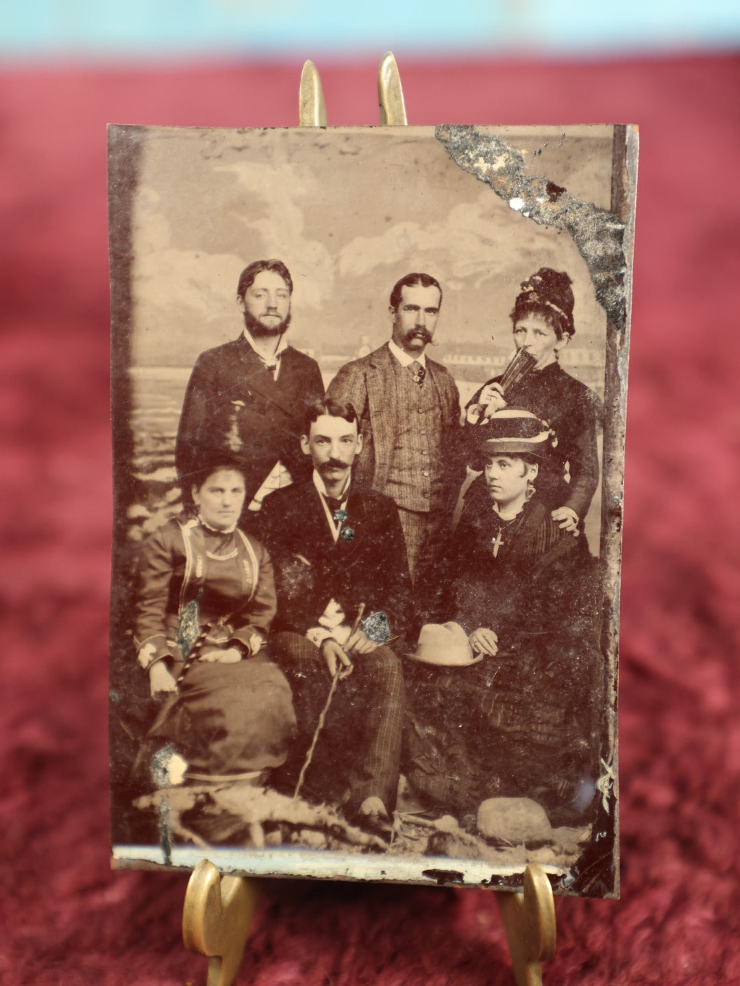 Lot 128 - Single Tintype Photo, Group  Of Three Men, Three Women, One Woman Has Large Cross Necklace, Another Is Hiding Her Mouth Behind A Fan