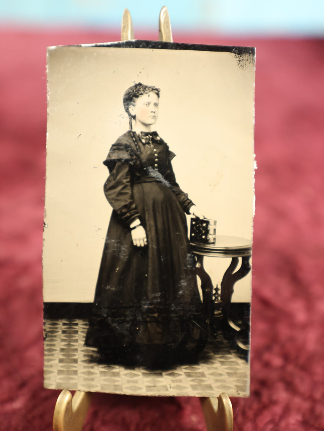 Lot 129 - Single Tintype Photo, Young Woman, Possibly Pregnant, Holding Photo Album On Table