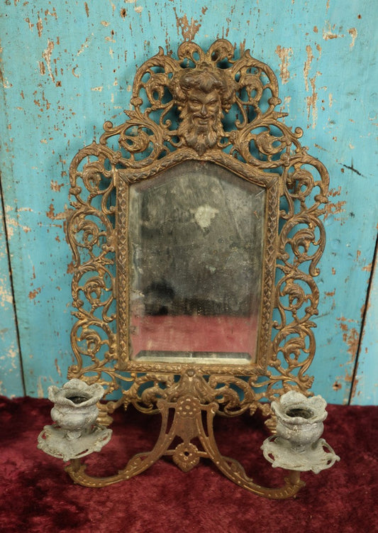 Lot 007 - Antique Cast Brass Bacchus, The Wine God, Ornate Wall Hanging Mirror With Tapered Candle Holders, Beveled Mirror, Note Heavy Deterioration Of Mirror