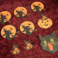 Lot 025 - Grouping Of Eight Plus Vintage Halloween Paper Cutouts Including Witches, Pumpkin, And Cat Face, With Extra Scraps