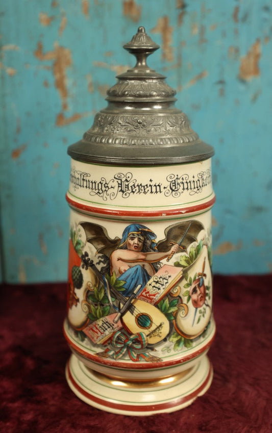 Lot 027 - Antique 1905 German Stein Having To Do With A Social Club, Featuring Winged Bat-Like Woman, Face Impaled Through Eye Ball, Augsburg Coat Of Arms, Signed Jos. (Joseph) Weber, Augsburg, With Markings