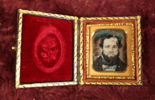 Lot 035 - Antique 1/16th Plate Daguerreotype Photograph In Intact Case Of Man With Beard, Flower On Red Pillow, Heavy Wear