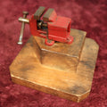 Lot 040 - Vintage Jeweler's Vice With Red Paint, Mounted On Two Tier Wood Block Stand