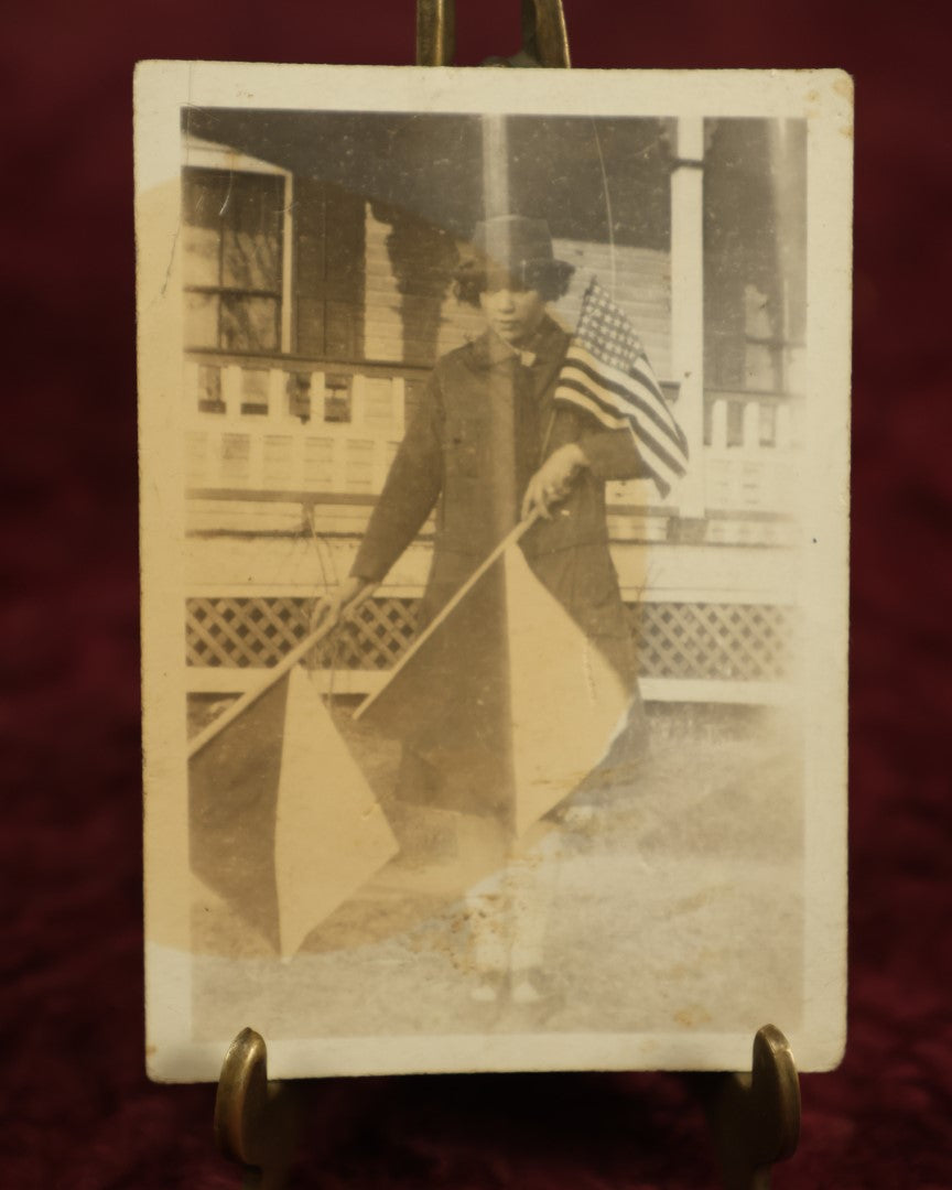 Lot 111 - Single Snapshot Photo, Woman With Flags, Wearing Peacoat And Hat