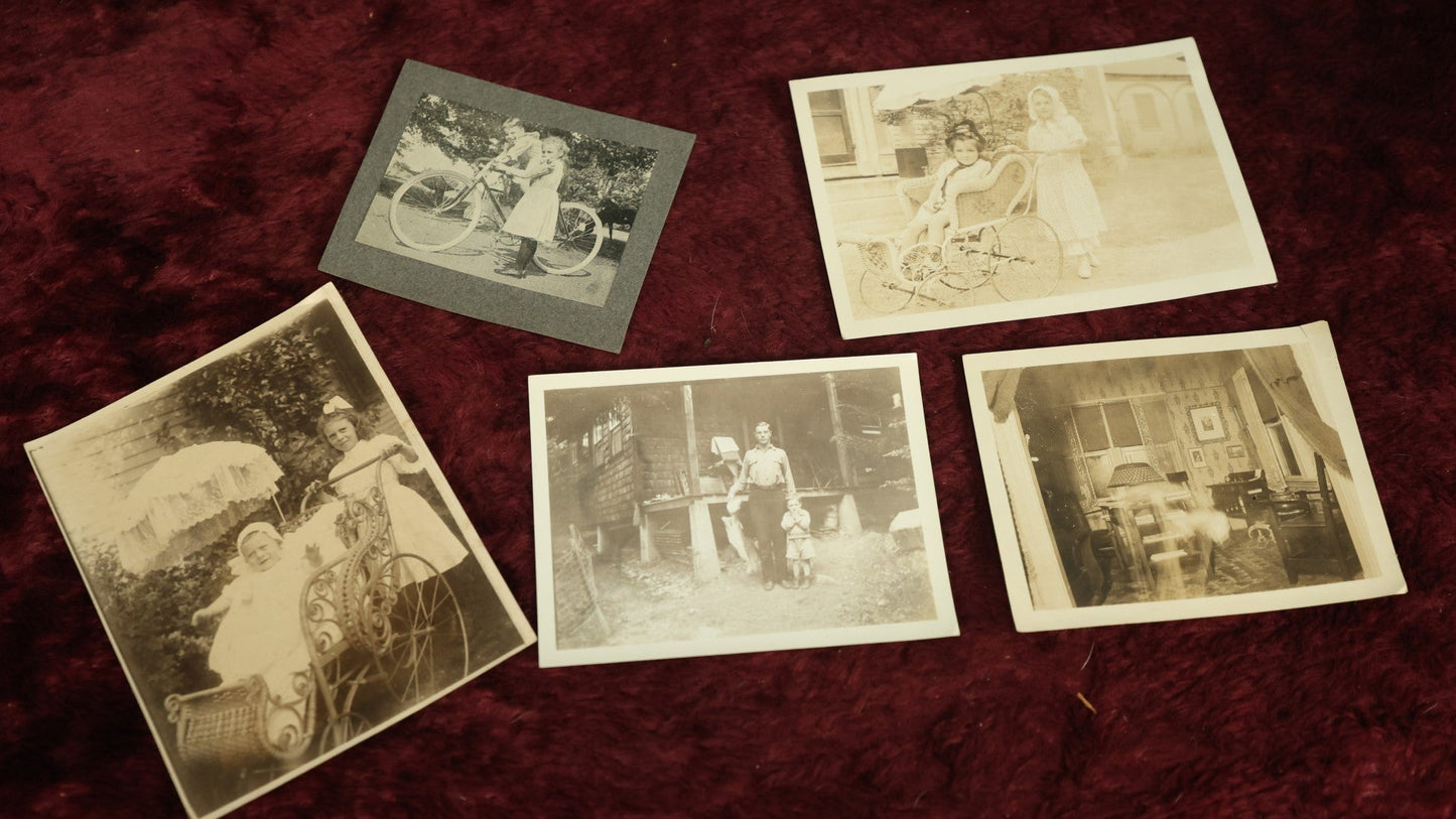 Lot 124 - Snapshot Grouping, Five Photos Of Children And Pets, Including Man Holding Fish, Kids On Bikes, In Prams, And Dog, Etc