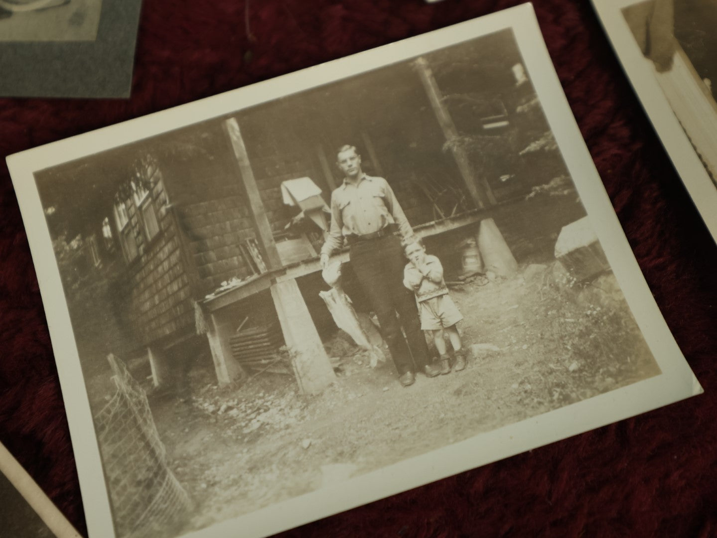 Lot 124 - Snapshot Grouping, Five Photos Of Children And Pets, Including Man Holding Fish, Kids On Bikes, In Prams, And Dog, Etc