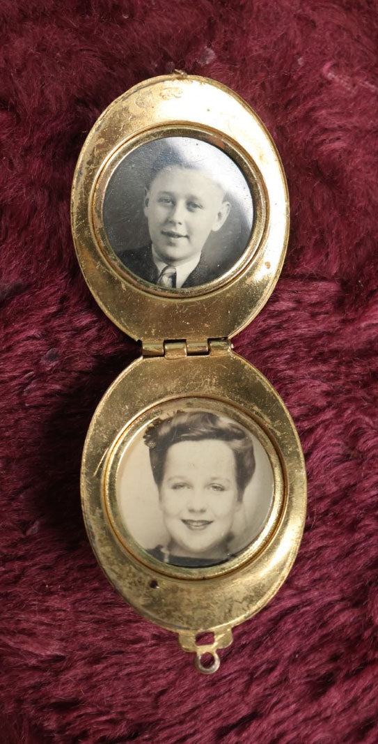 Lot 018 - Vintage Brass Locket With Grape Motif Containing Snapshot Photos Of A Young Boy And A Pretty Woman