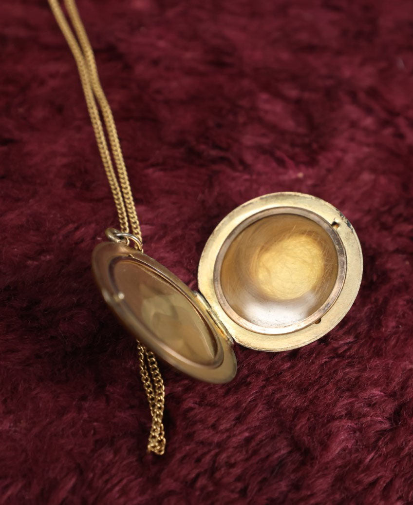 Lot 019 - Vintage Brass Locket On Gold Filled Chain Containing A Photo Of A Man And A Lock Of Blonde Hair