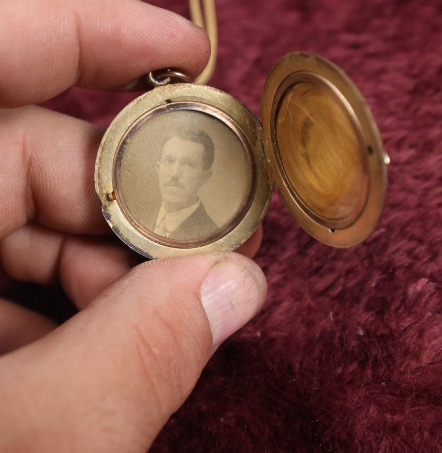 Lot 019 - Vintage Brass Locket On Gold Filled Chain Containing A Photo Of A Man And A Lock Of Blonde Hair