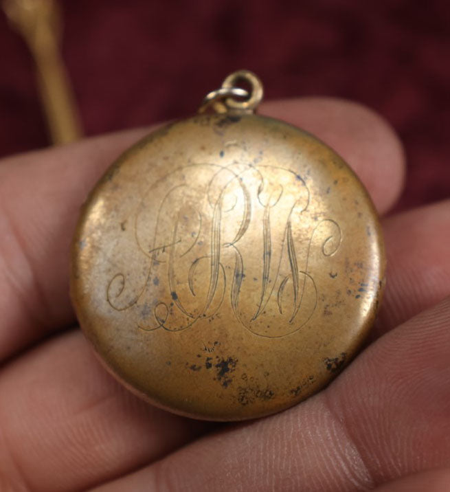 Lot 019 - Vintage Brass Locket On Gold Filled Chain Containing A Photo Of A Man And A Lock Of Blonde Hair