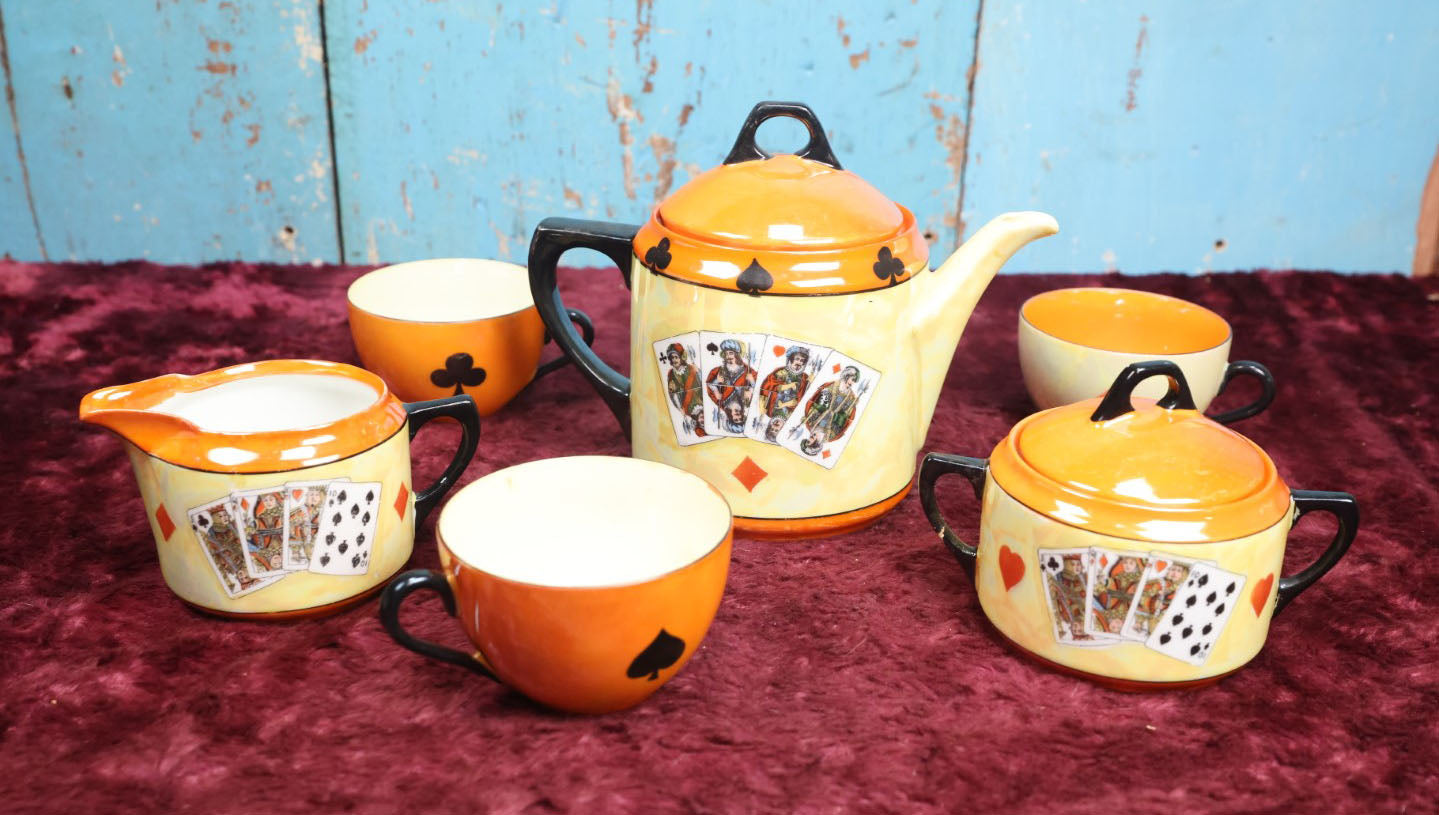 Lot 043 - Rudolf Wächter German Porcelain Lusterware Tea Set With Playing Card Motif, Includes Teapot, Sugar Bowl, Creamer, And Three Of Four Cups, Note Break On Sugar Bowl Arm