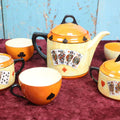 Lot 043 - Rudolf Wächter German Porcelain Lusterware Tea Set With Playing Card Motif, Includes Teapot, Sugar Bowl, Creamer, And Three Of Four Cups, Note Break On Sugar Bowl Arm