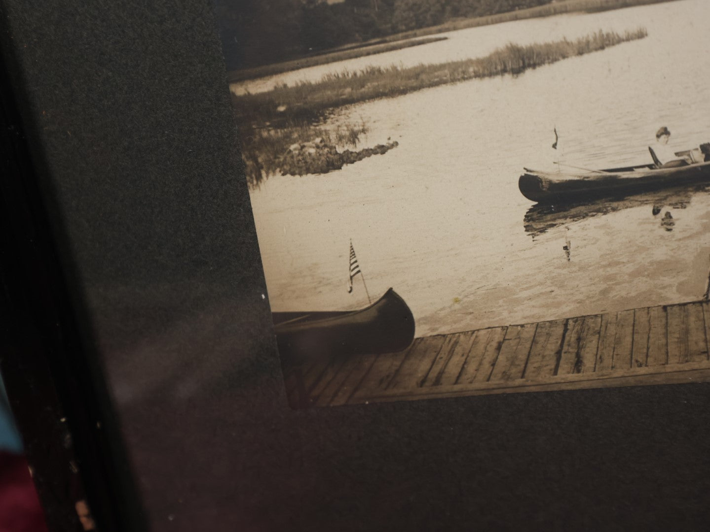 Lot 050 - Unusual Antique Framed Photo Of Two Women In A Canoe With A Skull And Crossbones / Jolly Roger Pillow, Boat Named Hiawatha, American Flag In Frame