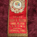 Lot 084 - Antique Odd Fellows Ribbon And Badge, Loyal Hugh H. Osgood Lodge No. 6920, I.O.O.F.M.U., Independent Order Of Odd Fellows, Manchester Unity, Taftville, Connecticut, Made By Whitehead And Hoag, Co.