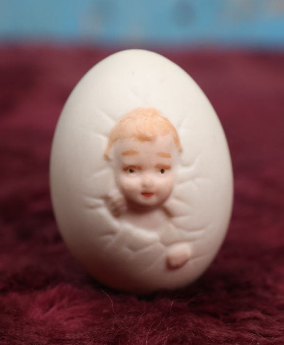 Lot 087 - Antique Bisque Porcelain "Birthing Egg," Baby Breaking Out Of Egg, Butt On Back, Hole In Bottom, Likely German