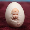 Lot 087 - Antique Bisque Porcelain "Birthing Egg," Baby Breaking Out Of Egg, Butt On Back, Hole In Bottom, Likely German