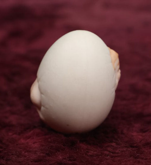 Lot 087 - Antique Bisque Porcelain "Birthing Egg," Baby Breaking Out Of Egg, Butt On Back, Hole In Bottom, Likely German